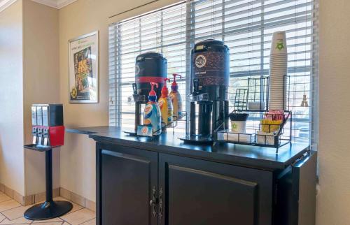 a counter with drinks and condiments on top of it at Extended Stay America Suites - Kansas City - Shawnee Mission in Merriam