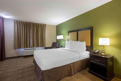 a hotel room with a large bed and a window at Extended Stay America Select Suites - Springfield - South in Springfield