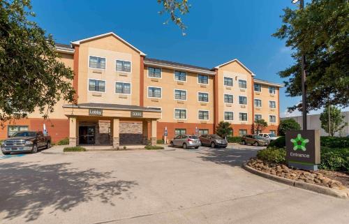 a large building with cars parked in a parking lot at Extended Stay America Suites - New Orleans - Metairie in Metairie