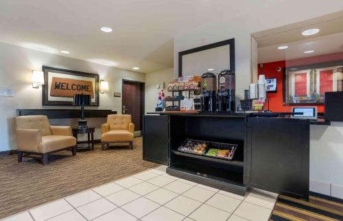 a lobby with a waiting room with chairs and a counter at Extended Stay America Suites - New Orleans - Metairie in Metairie