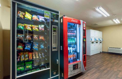 a cocacola soda machine in a store next to a soda at Extended Stay America Suites - New Orleans - Metairie in Metairie