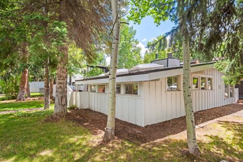 a house in the woods with trees at Aspen West End Home in Aspen