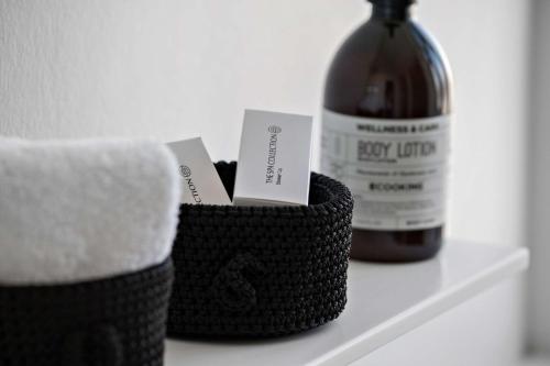 a bottle of wine and towels on a shelf at Best Western Plus Hotel Eyde in Herning