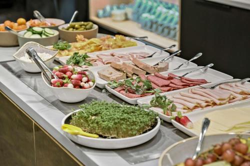 a buffet with many different types of food on a table at Best Western Plus Hotel Eyde in Herning