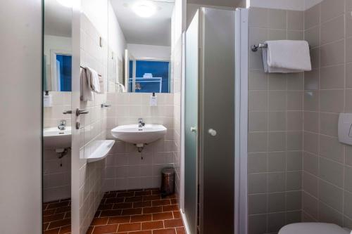 a bathroom with a sink and a toilet at Scandic Ringsted in Ringsted