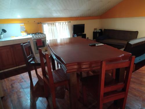 a living room with a wooden table and chairs at Sun Havens Apartments & Suites in Bocas del Toro