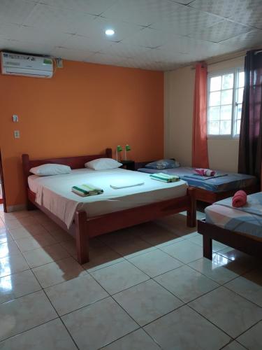 a bedroom with two beds in a room at Sun Havens Apartments & Suites in Bocas del Toro