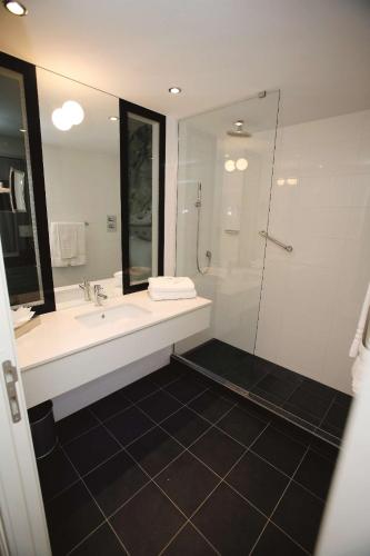a bathroom with a sink and a shower at Radisson Blu Hotel East Midlands Airport in Castle Donington