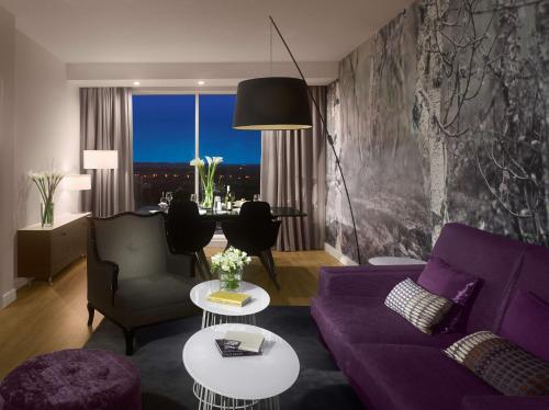 a living room with a purple couch and a table at Radisson Blu Hotel East Midlands Airport in Castle Donington