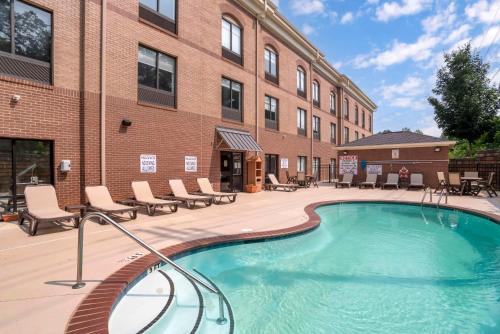 a swimming pool in front of a building at Comfort Suites At WestGate Mall in Spartanburg