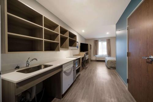 a kitchen with a sink and a counter top at WoodSpring Suites Wixom - Novi in Wixom