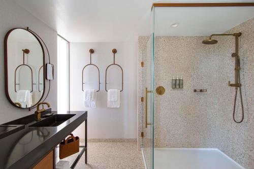 a bathroom with a shower and a sink and a tub at Hotel Citrine, Palo Alto, a Tribute Portfolio Hotel in Palo Alto