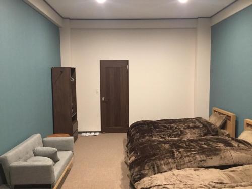 - une chambre avec un lit, un canapé et une chaise dans l'établissement Iitoko - Vacation STAY 43595v, à Iitoyo