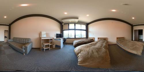 a large room with two beds and a desk at Iitoko - Vacation STAY 43906v in Iitoyo