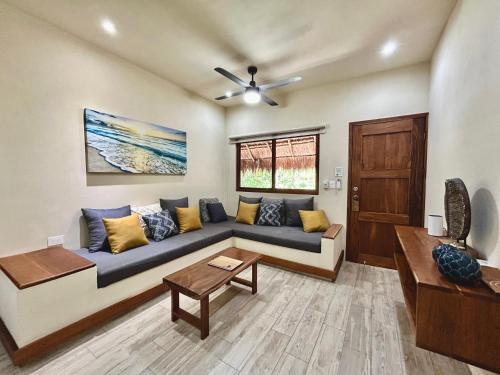 a living room with a couch and a table at Aldea Xaan Ha Tulum in Tulum