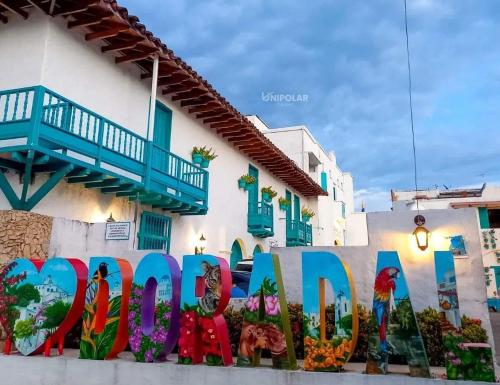 a sign that says open in front of a building at Santorini colombiano en Doradal in Puerto Triunfo