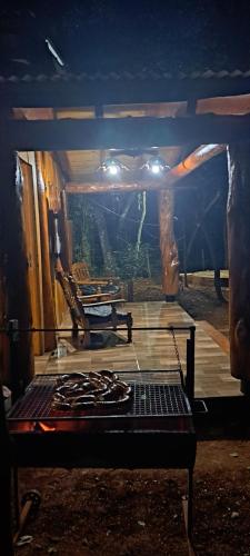 a view of a room with a table and a stove at Cabañas Libertad en Misiones in Puerto Bossetti