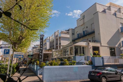 a street in a city with buildings and a car at Hotel Diamond in Rimini