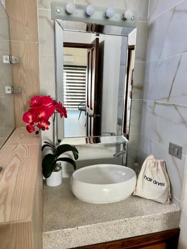 a bathroom with a sink and a large mirror at Casa Boutique Maria Bonita in La Manzanilla