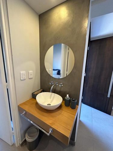 a bathroom with a sink and a mirror at Bosques de Mayo in Maipú