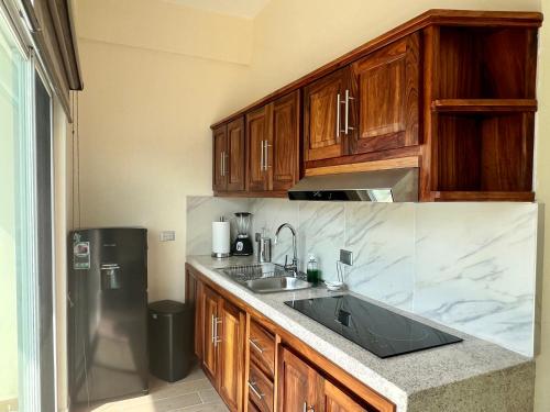 a kitchen with a sink and a refrigerator at Casa Boutique Maria Bonita in La Manzanilla