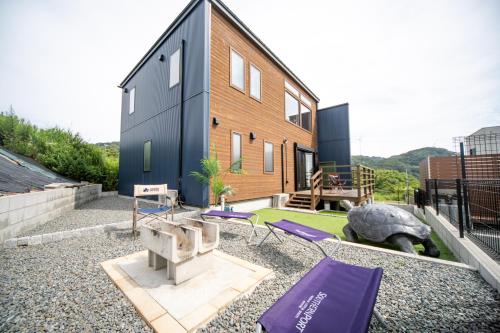 a house with a backyard with purple cushions at Awaji Seaview Resort in Nojimakifune in Kusumoto