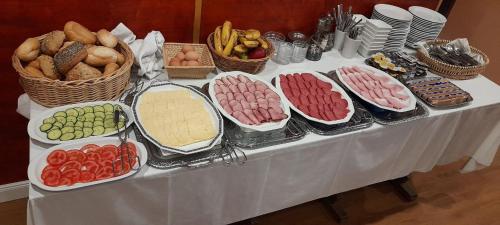 a table with many different types of food on it at Ihre Pension in Amerang in Amerang