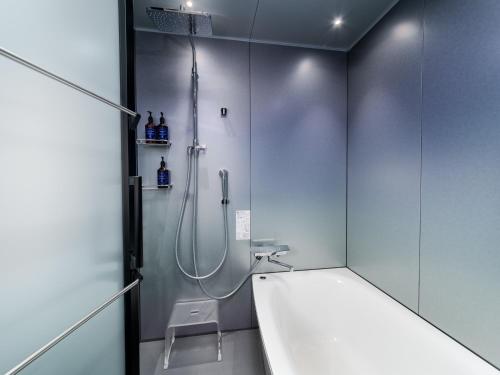 a bathroom with a shower and a sink at MIMARU Kyoto Nishinotoin Takatsuji in Kyoto