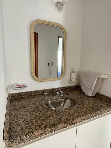 a bathroom with a sink and a mirror at DUPLEX BV in Bell Ville