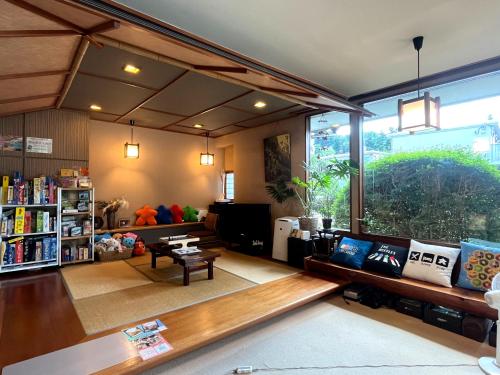 a living room filled with furniture and a large window at Mitake in Hakone
