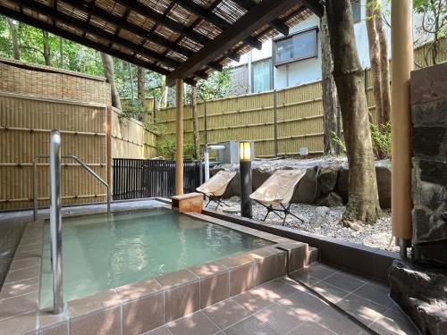 a pool of water with a table and chairs at Mitake in Hakone