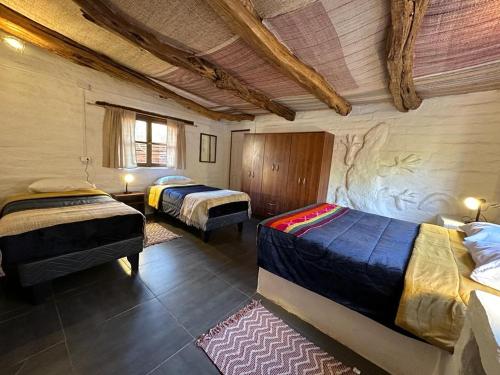 Postel nebo postele na pokoji v ubytování CaminAndes Hostal