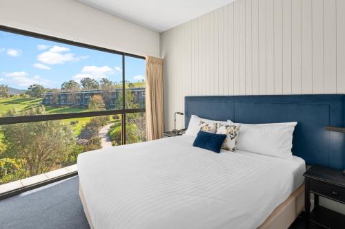 a bedroom with a large bed and a large window at Balgownie Estate Yarra Valley in Yarra Glen