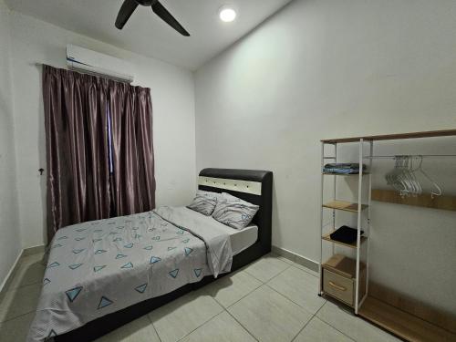 a small bedroom with a bed and a window at BSP21 Family Homestay in Jenjarum