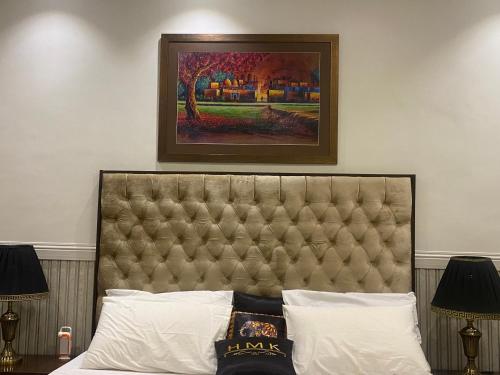 a painting above a bed in a hotel room at Hotel Milton in Islamabad