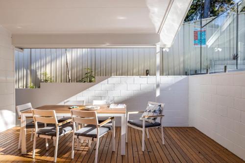 a dining room with a table and chairs at Bentley Beach Villa in Nelson Bay