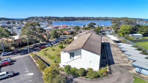 an aerial view of a white building with a parking lot at unit 9 11 Kyeamba Street, Merimbula in Merimbula