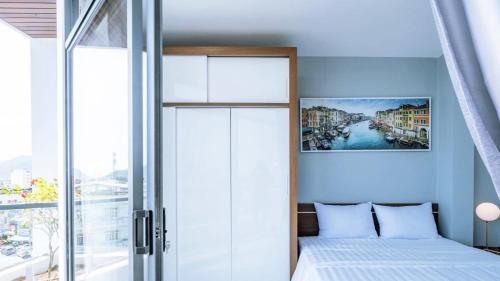 a bedroom with a bed and a large window at Hoàng Anh Hotel in Nha Trang