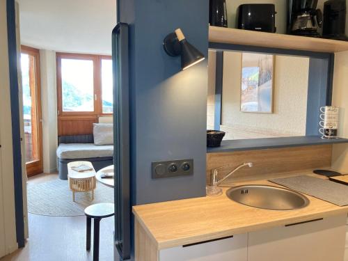 une cuisine avec un évier et un salon dans l'établissement Appartement rénové au cœur d'Avoriaz, 4/5 pers, avec balcon et accès internet - FR-1-634-93, à Morzine
