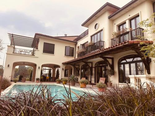 a house with a swimming pool in front of it at Casa XiX villa Venuestay in Vĩnh Phúc