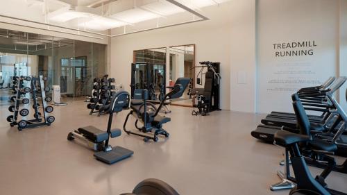 a gym with several rows of exercise bikes and treadmills at The Heaven Resort in Ansan