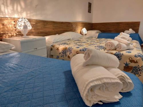 two beds with towels on them in a bedroom at Casa tra Cielo e Mare in Lipari