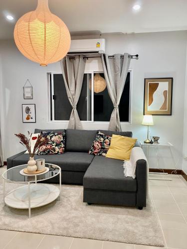 a living room with a couch and a table at Baan Patcharintorn Samui in Chaweng