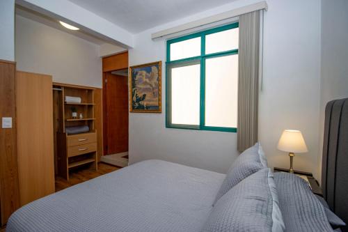 Schlafzimmer mit einem Bett und einem Fenster in der Unterkunft New! Bamboo Rooftop (Jacuzzi & Fun) in Cuernavaca