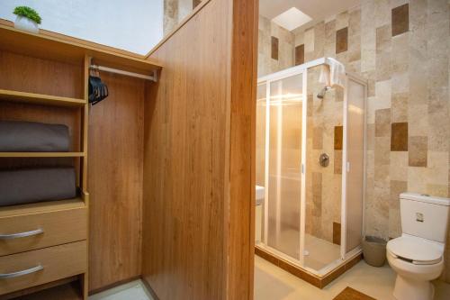 a bathroom with a toilet and a shower at New! Bamboo Rooftop (Jacuzzi & Fun) in Cuernavaca
