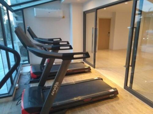 a gym with two treadmills and a treadmill at Worita Cove Hotel in Na Jomtien