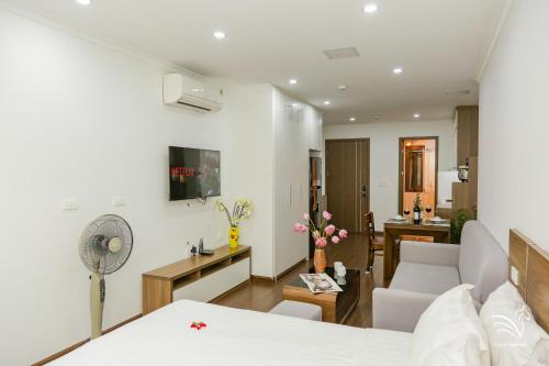 a living room with a white couch and a living room at Pegasy Apartments & Travel in Hanoi