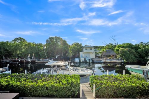 a boat is docked at a marina at Mojito Breeze Getaway home in Tavernier