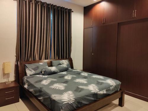 a bedroom with a bed and a window with curtains at Nice semi D house at Tangkak in Tangkak