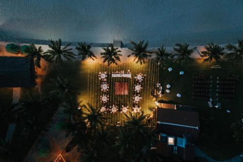 an aerial view of a hotel at night with palm trees at Palm Garden Beach Resort & Spa in Hoi An